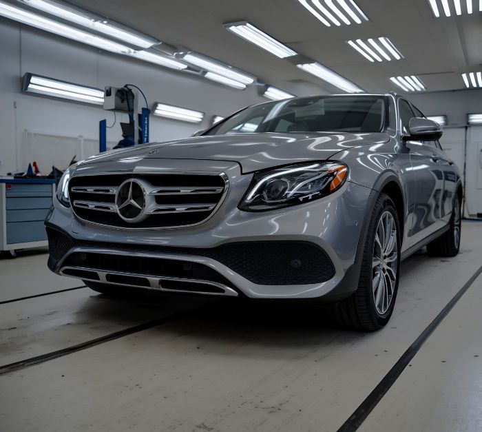 Mercedes-sedan-in-paint-booth-at-downtown-garage-and-auto-body