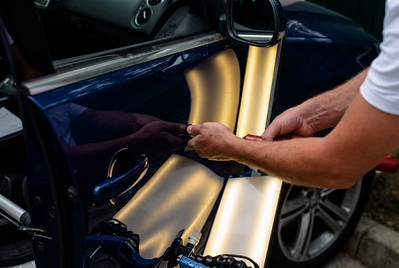 PDR Technician performing paintless dent repair-Auto Paint Repair