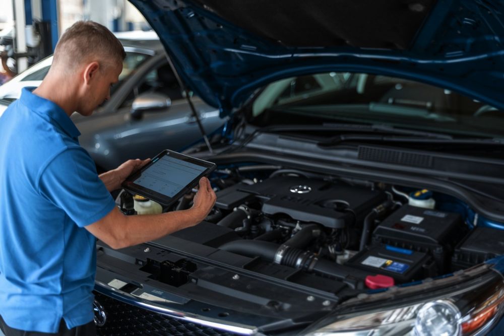 Auto Body technician lookiing at diagnostics after a toyota repair at Downtown Garage and Auto Body fredericksburg Auto-Body-technician-lookiing-at-diagnostics-after-a-toyota-repair-at-Downtown-Garage-and-Auto-Body-fredericksburg